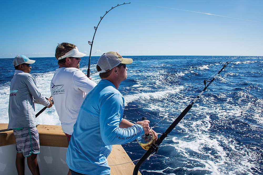 three anglers fishing on a boat