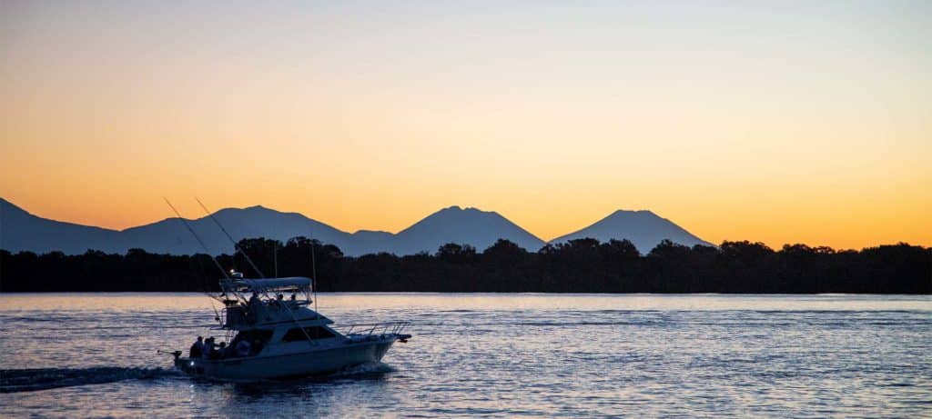 boat on the water in El Salvador at sunset