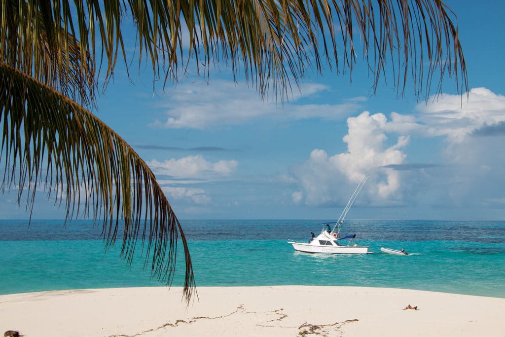 A sport fishing boat off the shore of The Seychelles beach.