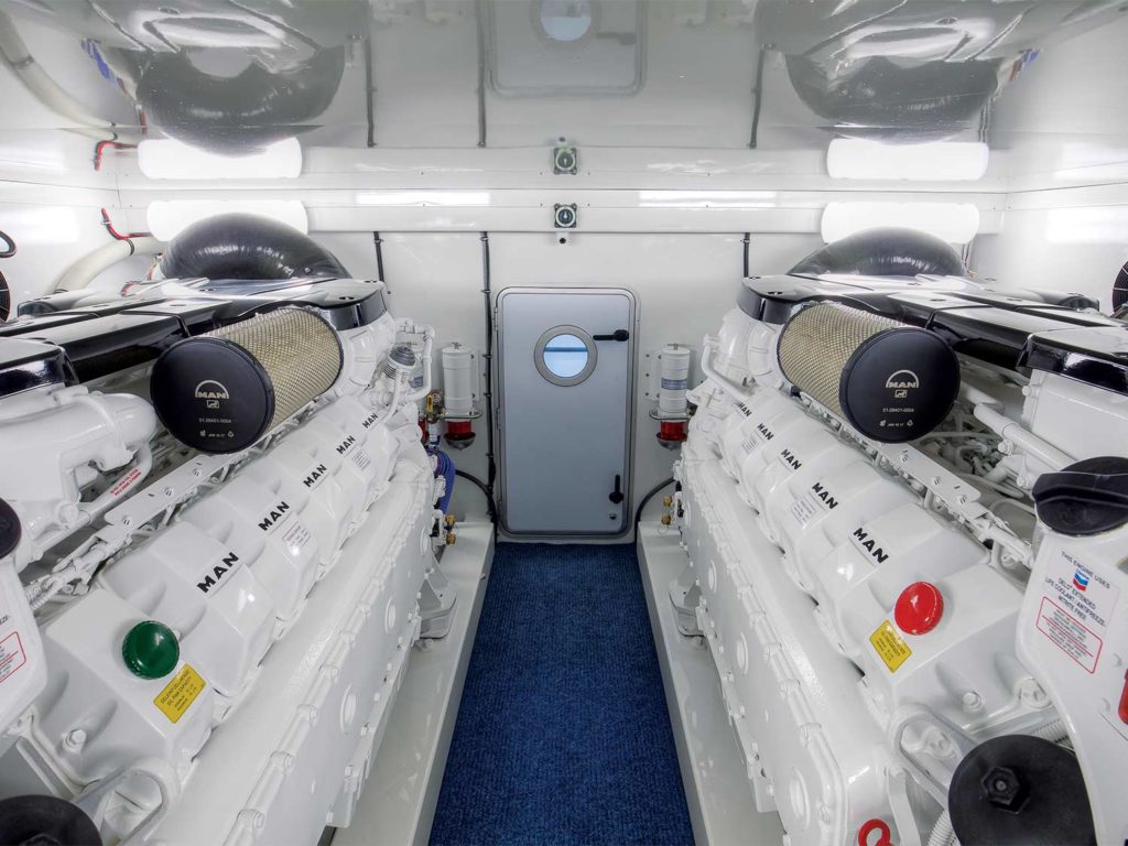 A sparkling clean, white boat engine room.