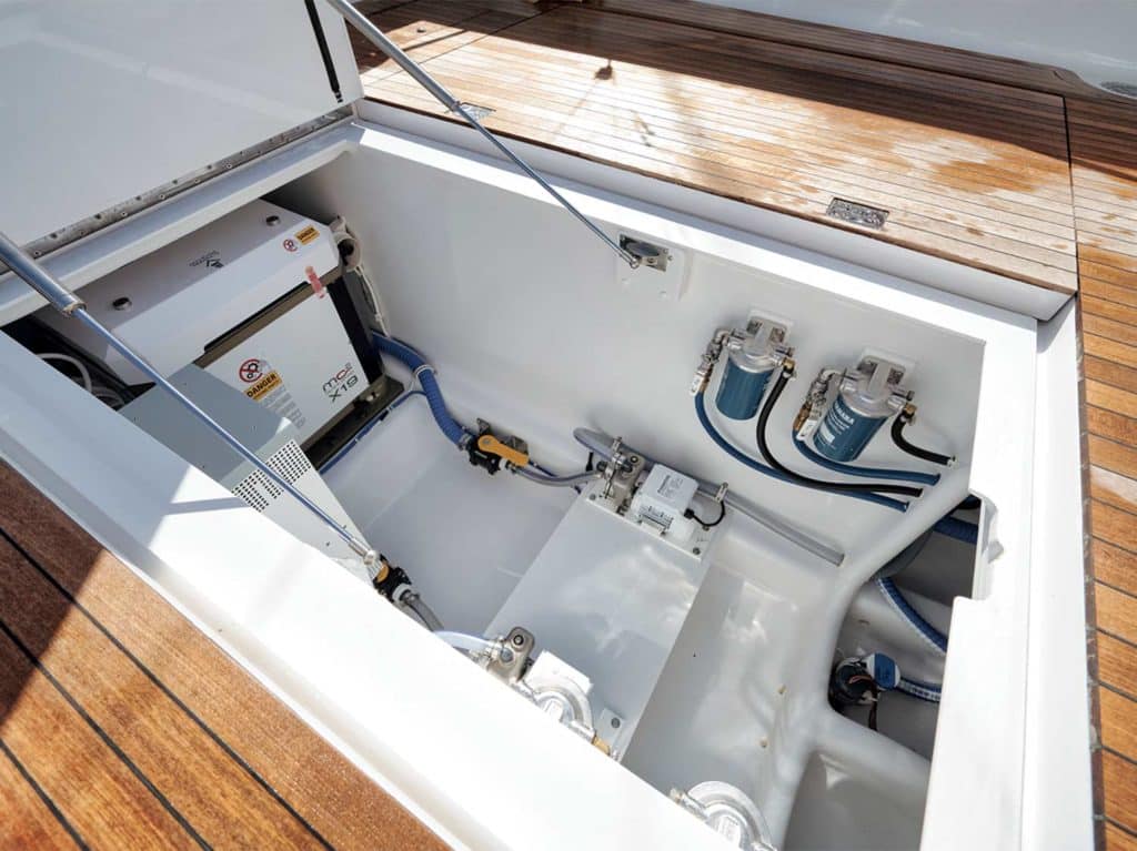 A hatch opens in the cockpit deck of a sport-fishing boat.