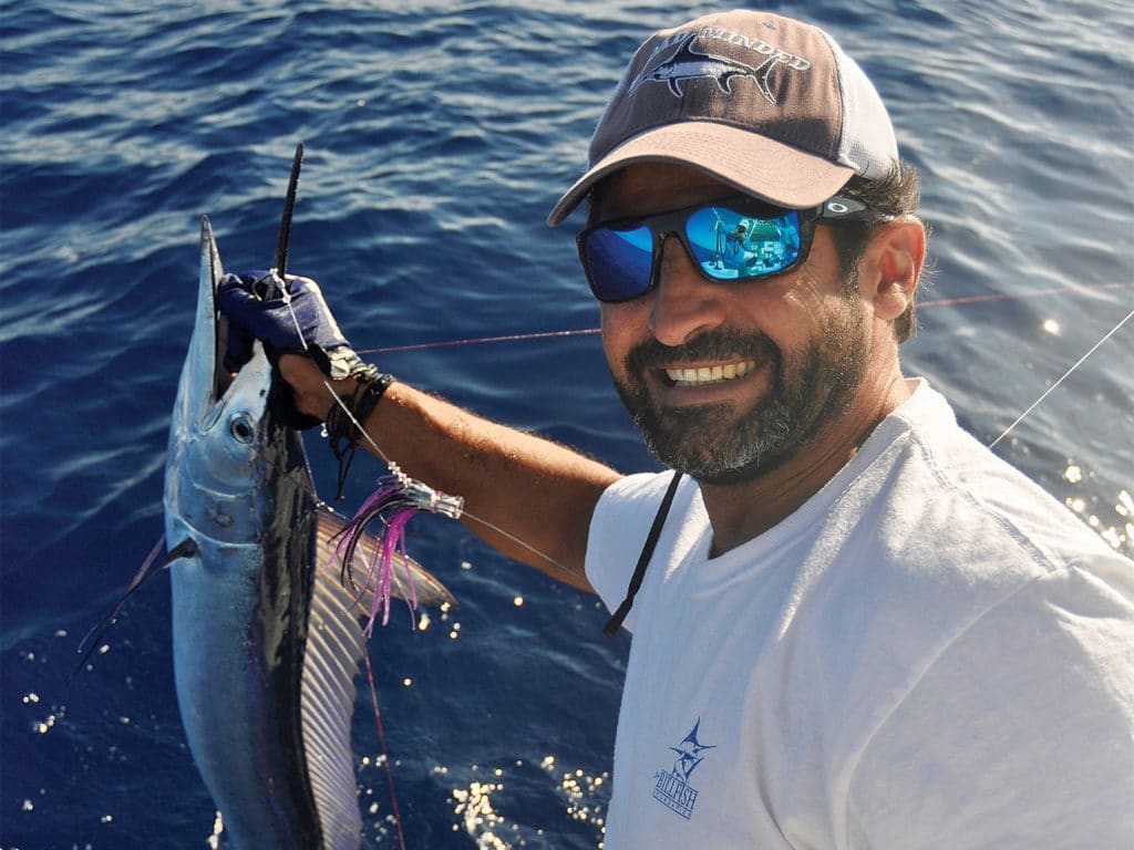 A sport-fishing angler holding up a spearfish.