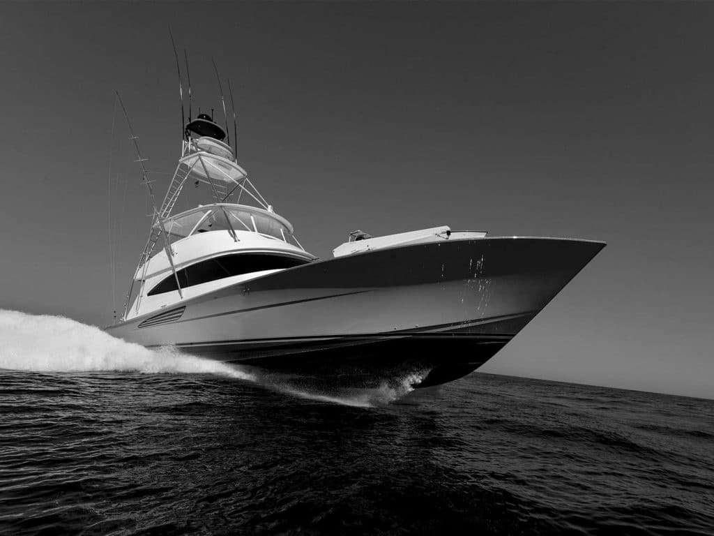 A black and white image of a sport-fishing boat on the water.