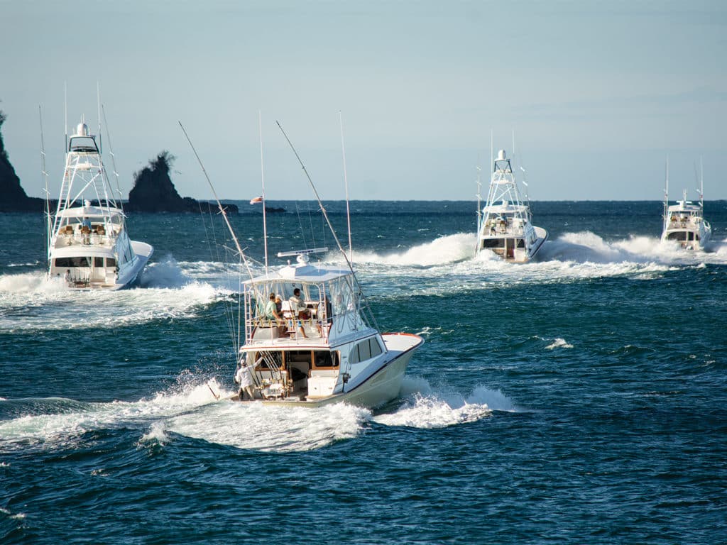 A fleet of sport fishing boats on the water.