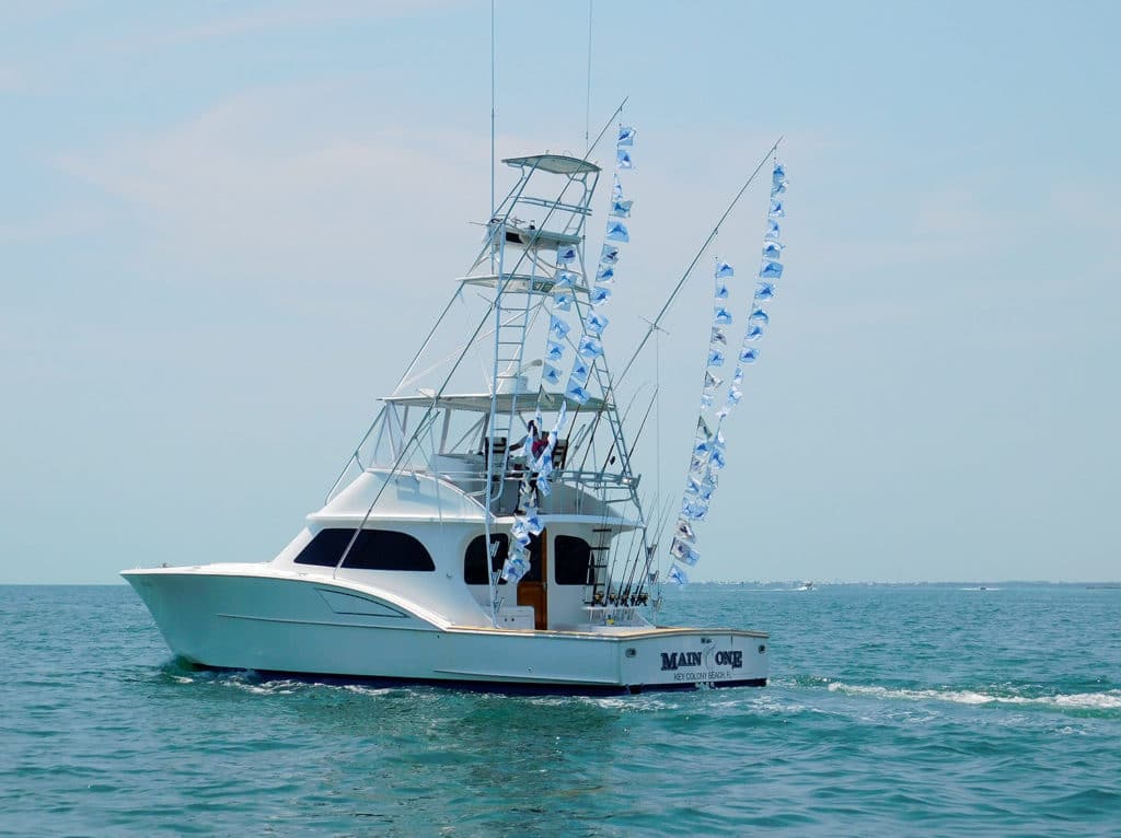 A sport fishing boat flying fishing flags.