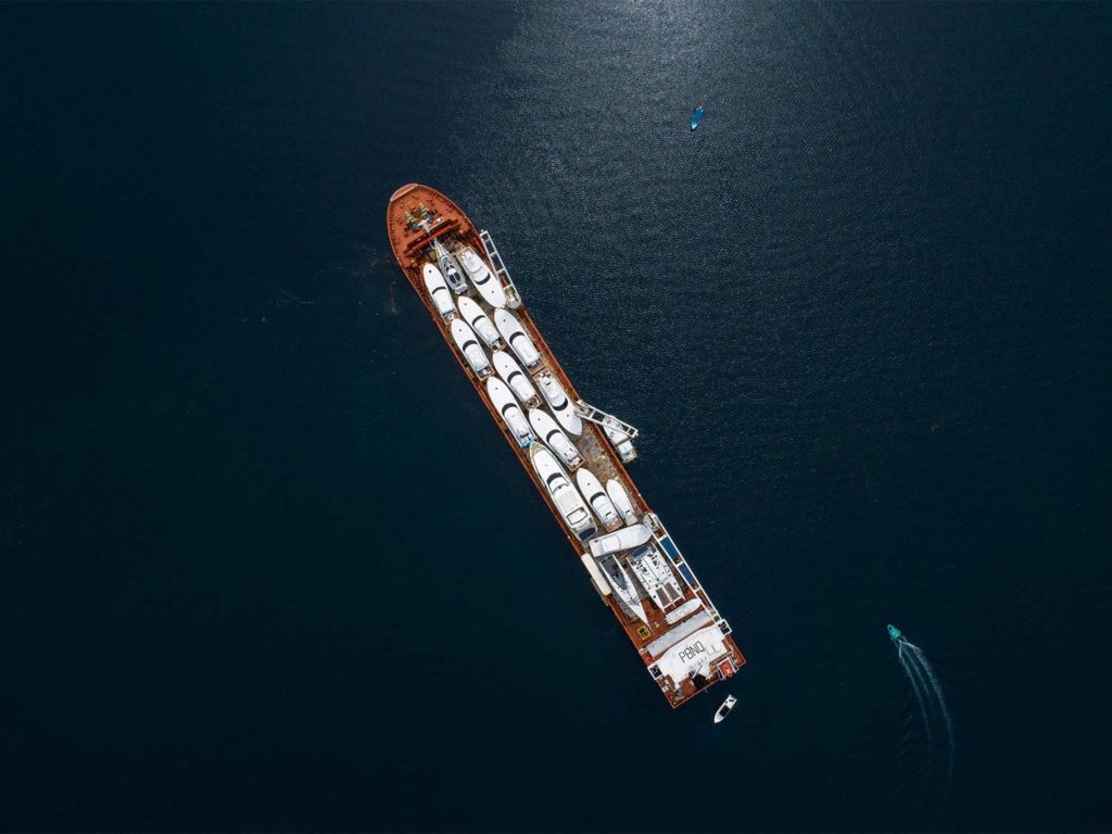 A shipping vessel loaded with sport-fishing boats.