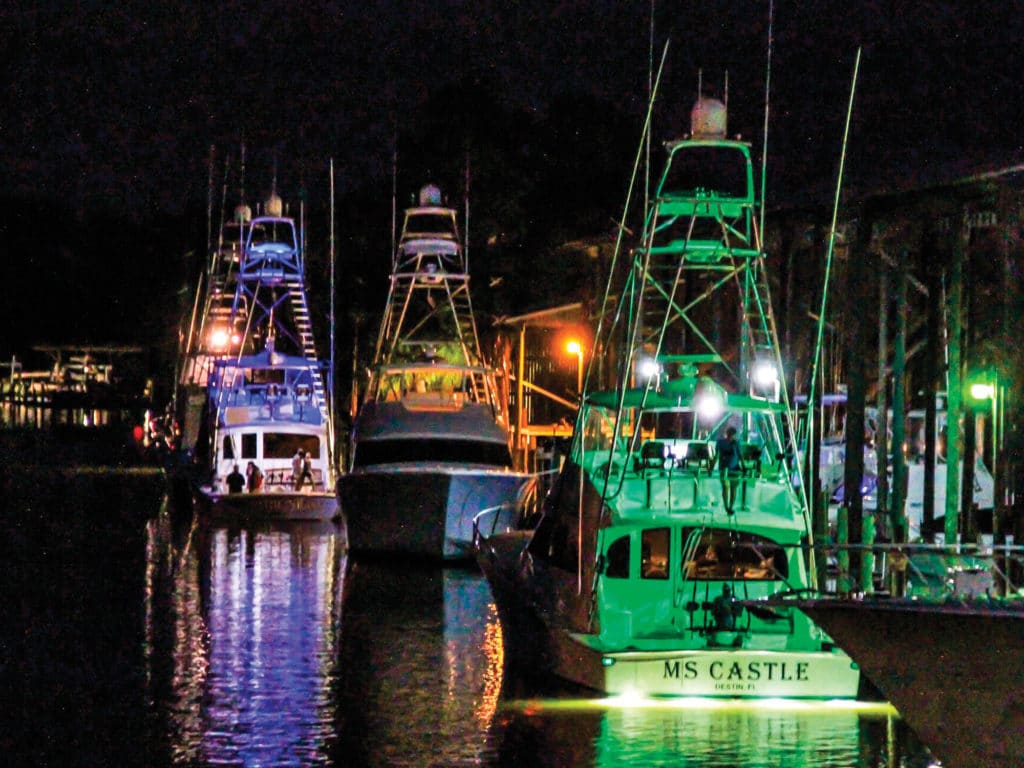 sport fishing boats in water at night