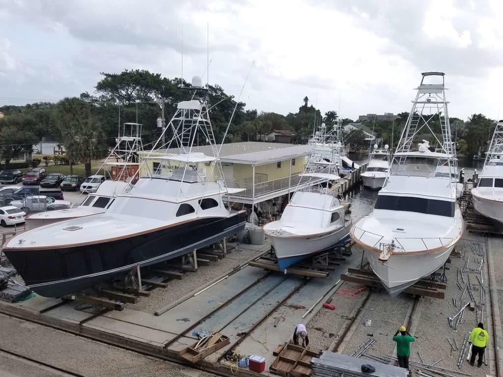 Several sport-fishing boats in dry dock.