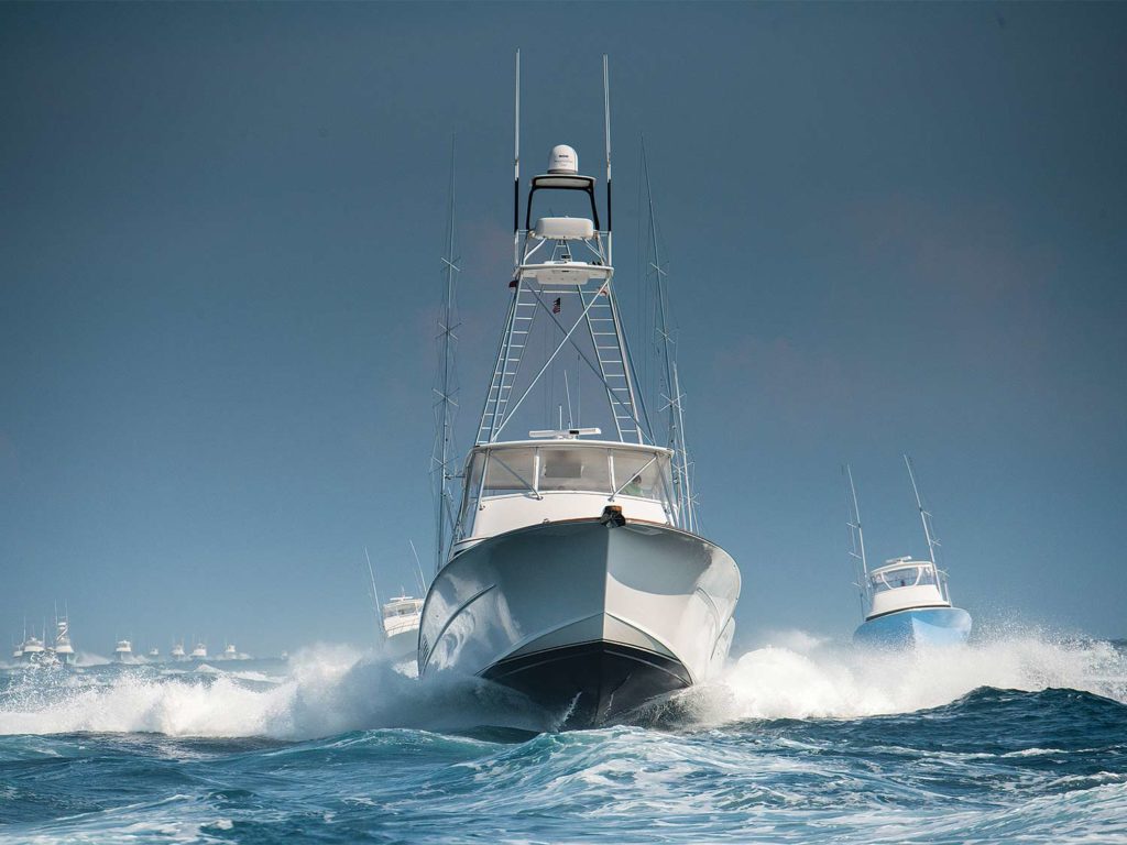 A fleet of sport fishing yachts on the water.