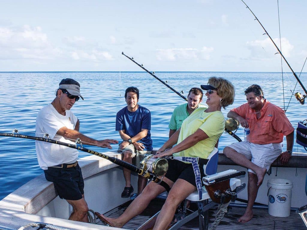 A sport-fishing team in the cockpit of a boat.