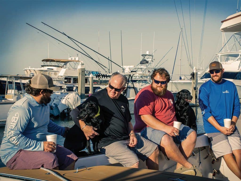 A family sits on a boat deck.