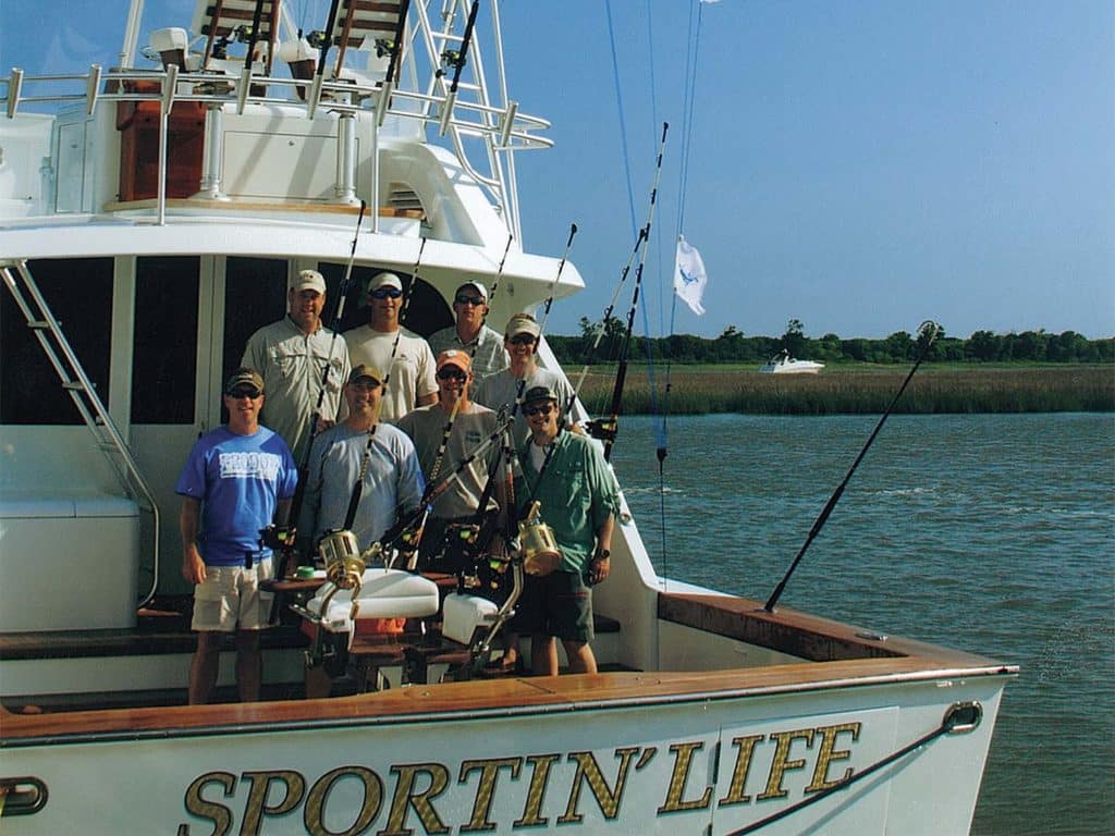A fishing crew on the deck of a boat.