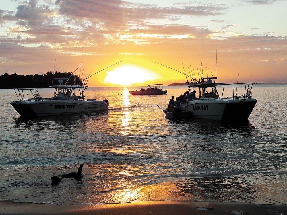 two sport fishing boats at sunset