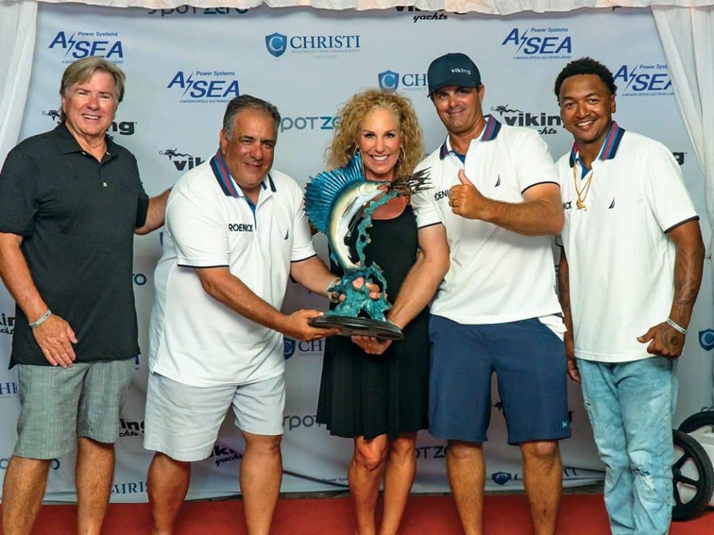 A sport-fishing team stands at an award ceremony.