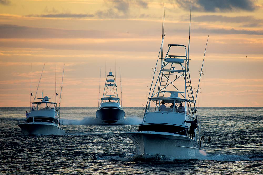 three sport fishing boats at sunset