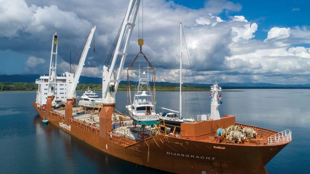 A shipping vessel loaded with sport-fishing boats.