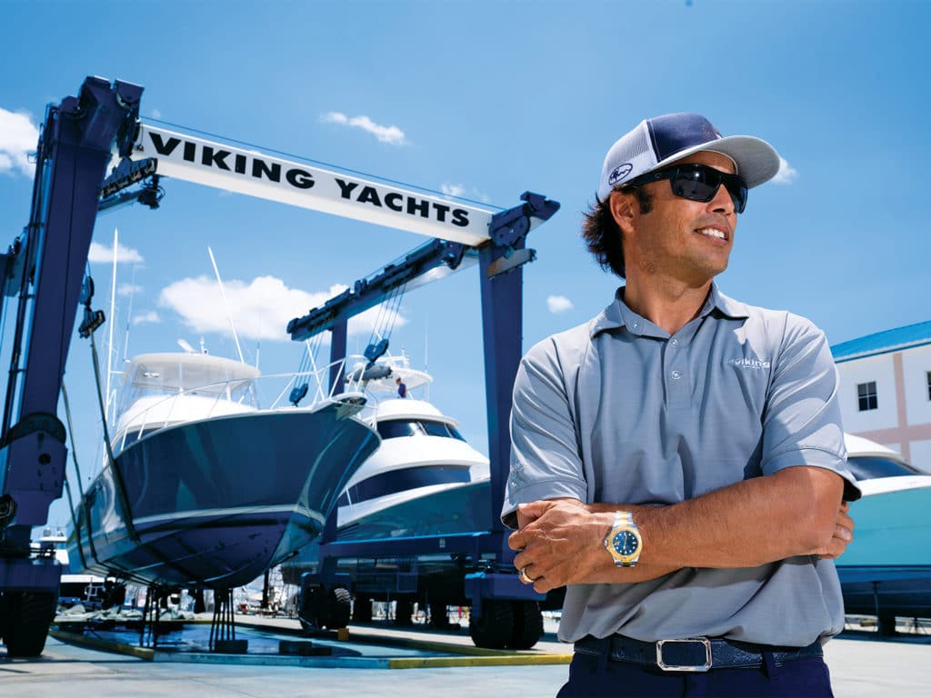 A boat captain standing in a viking yacht company dry dock.