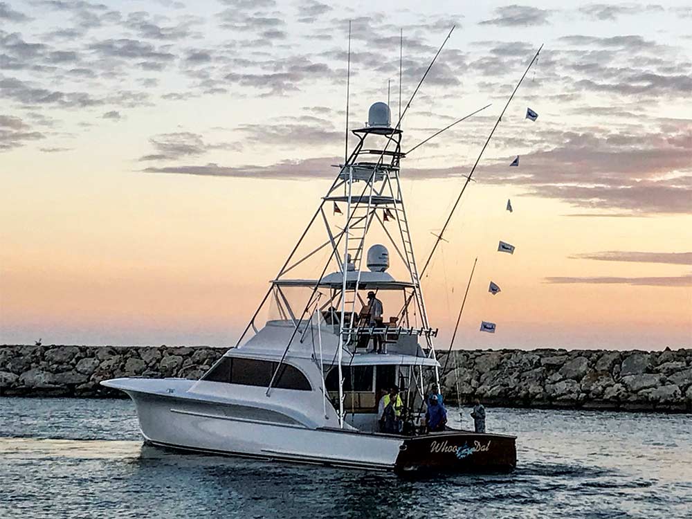 whoo dat fishing boat on the water at sunset