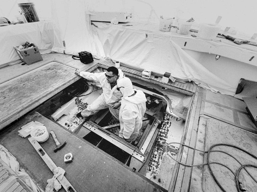 Two men upgrading a boat.