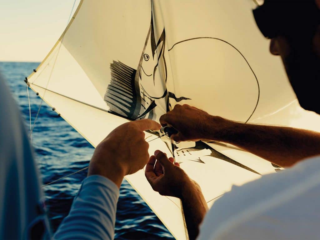 Two anglers adjusting kite.