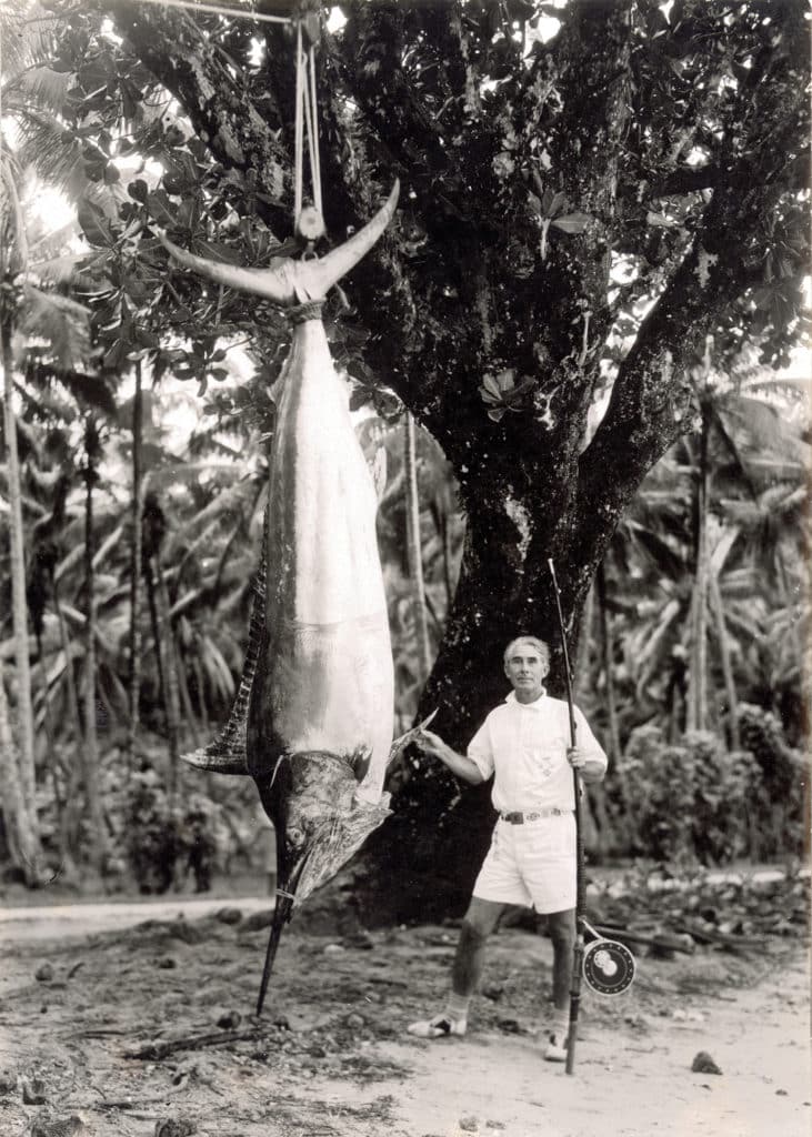 Black and white image of Zane Grey with a large marlin.