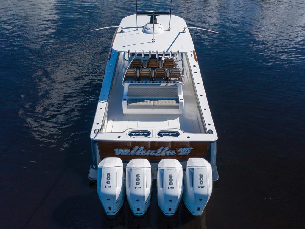 A boat with four outboard motors.