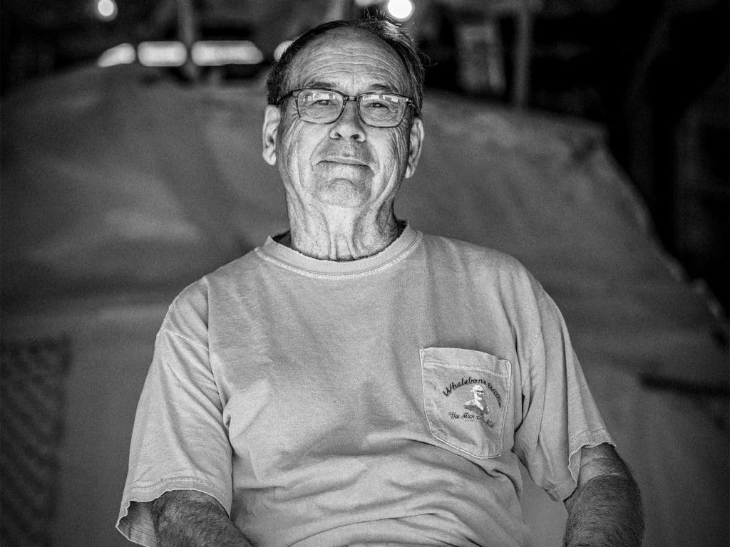 A black and white image of Sunny Briggs, a boat builder.