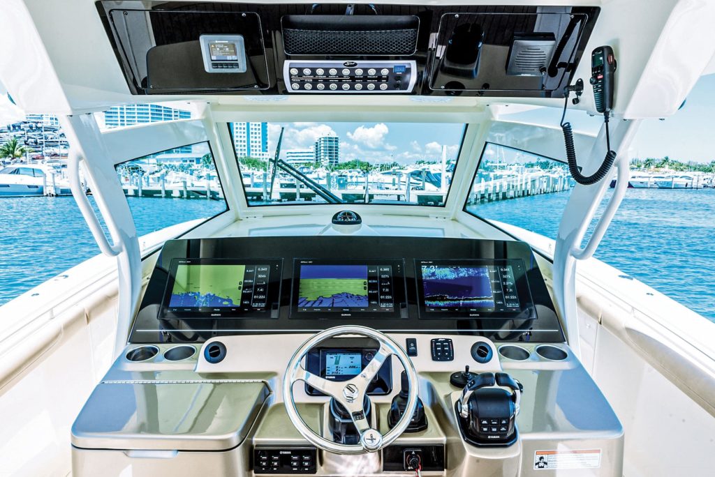 The wrap-around glass shield of a center console boat.