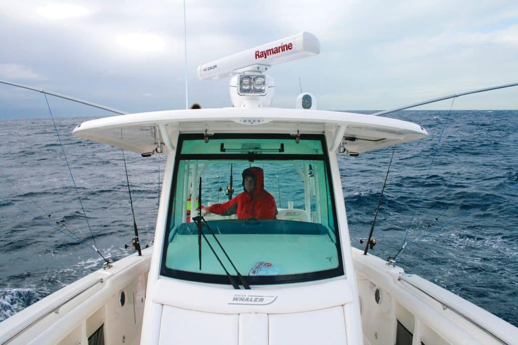 A center console boat showing a tempered-glass windshield.