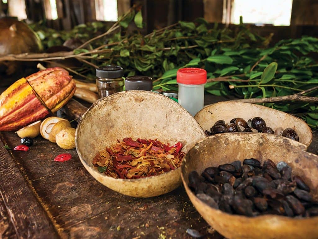 Cacao and spices in a bowl on a table.