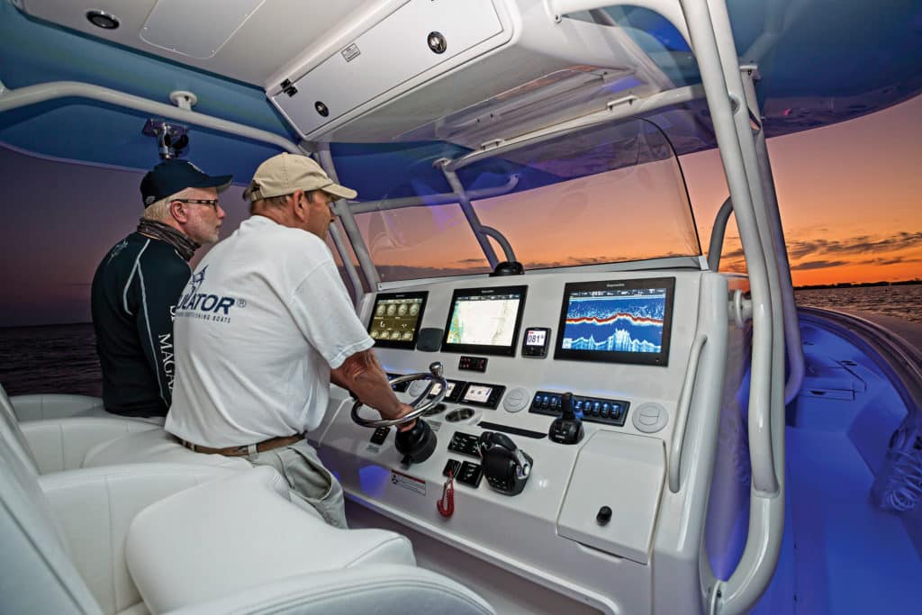 A boat captain at the helm of a fishing boat.