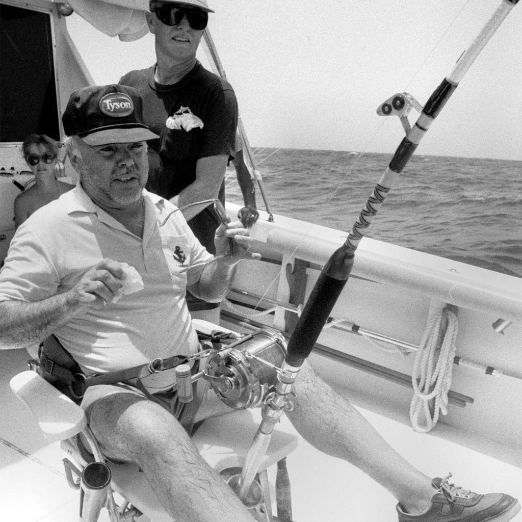 A sport-fishing angler sitting in the fighting chair.