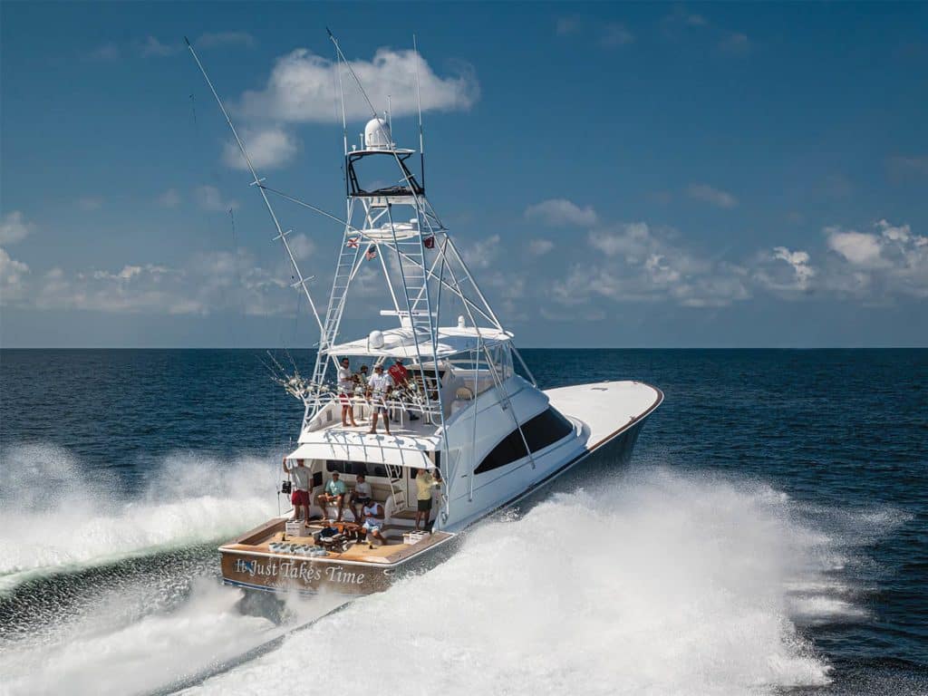A sport-fishing boat on the water creating waves and wake.