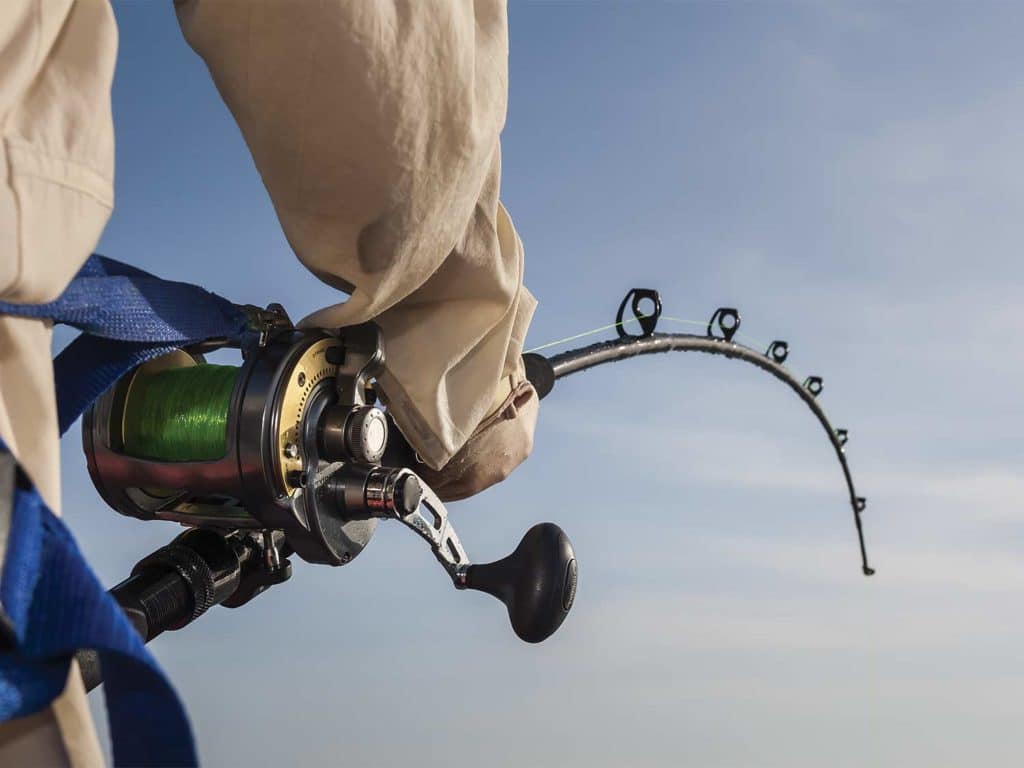 A hand holding a custom fishing rod.