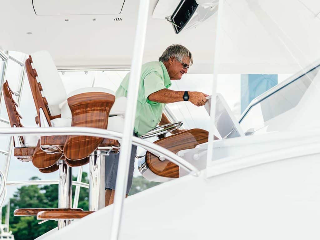 A boat captain at the helm of a boat.