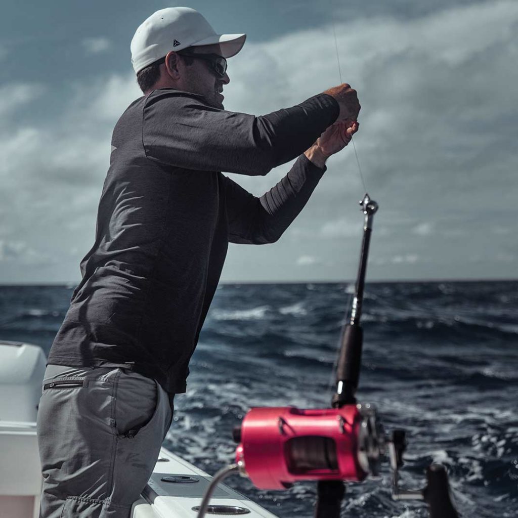 A crewmate working on rigging.