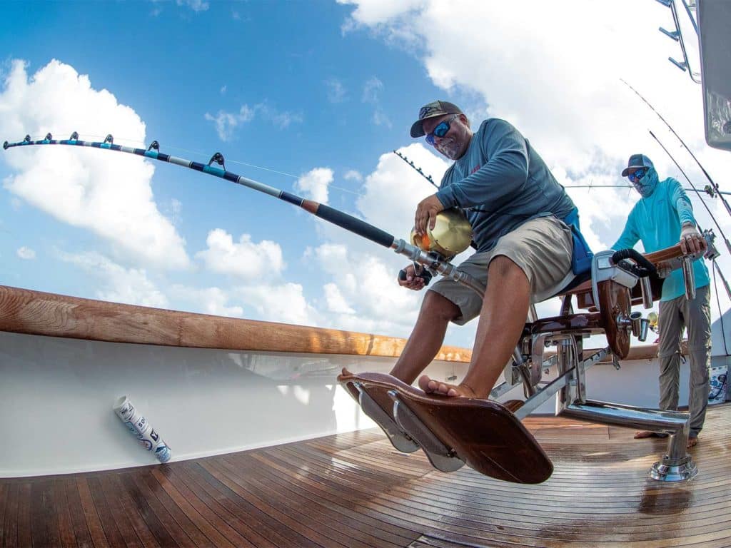 A sport-fishing angler reeling in a catch.