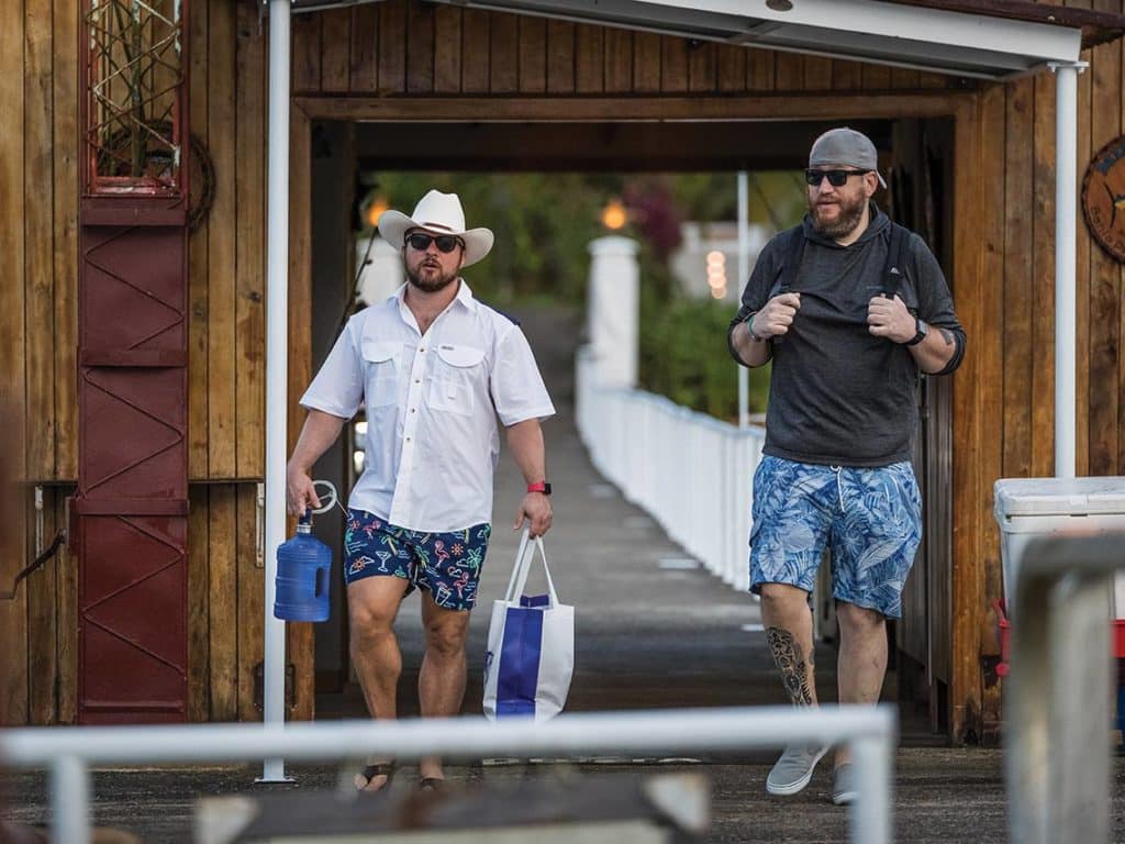 Two men walking down a pier at Tropic Star Lodge.