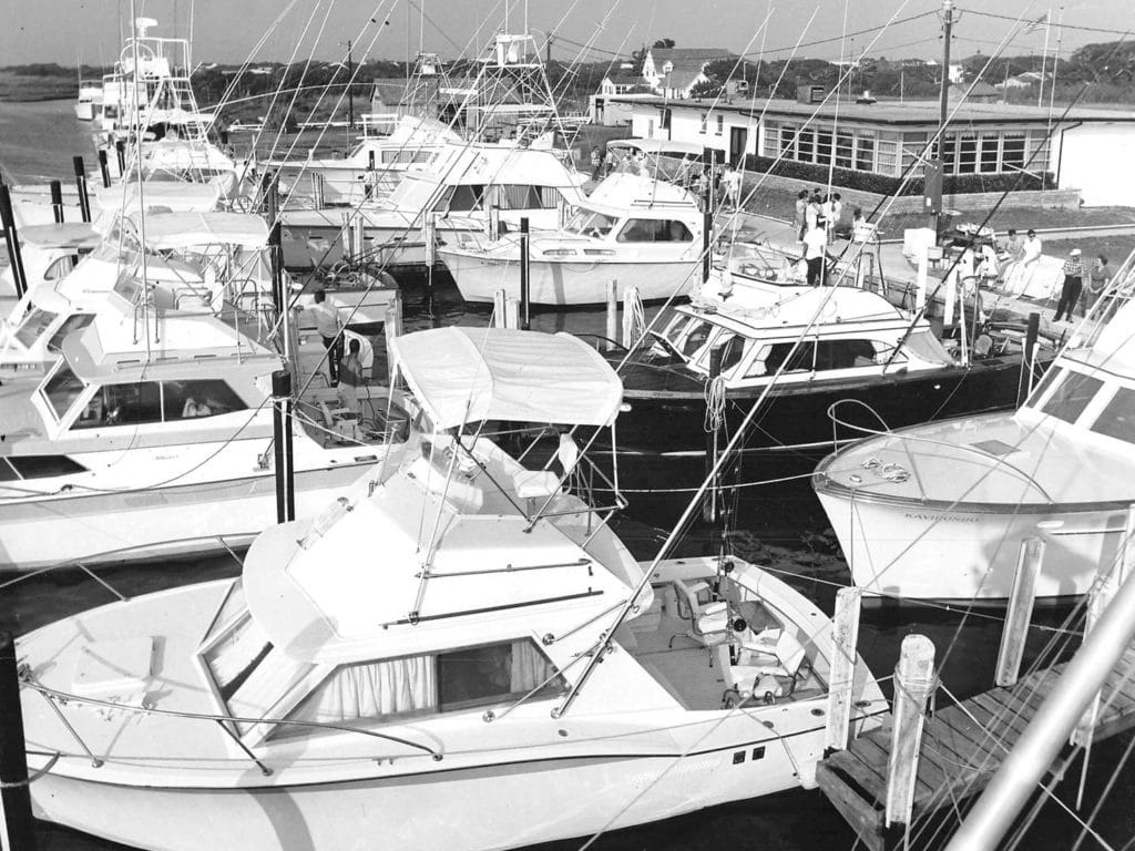 A black and white image of sport-fishing boats docked in the marina.