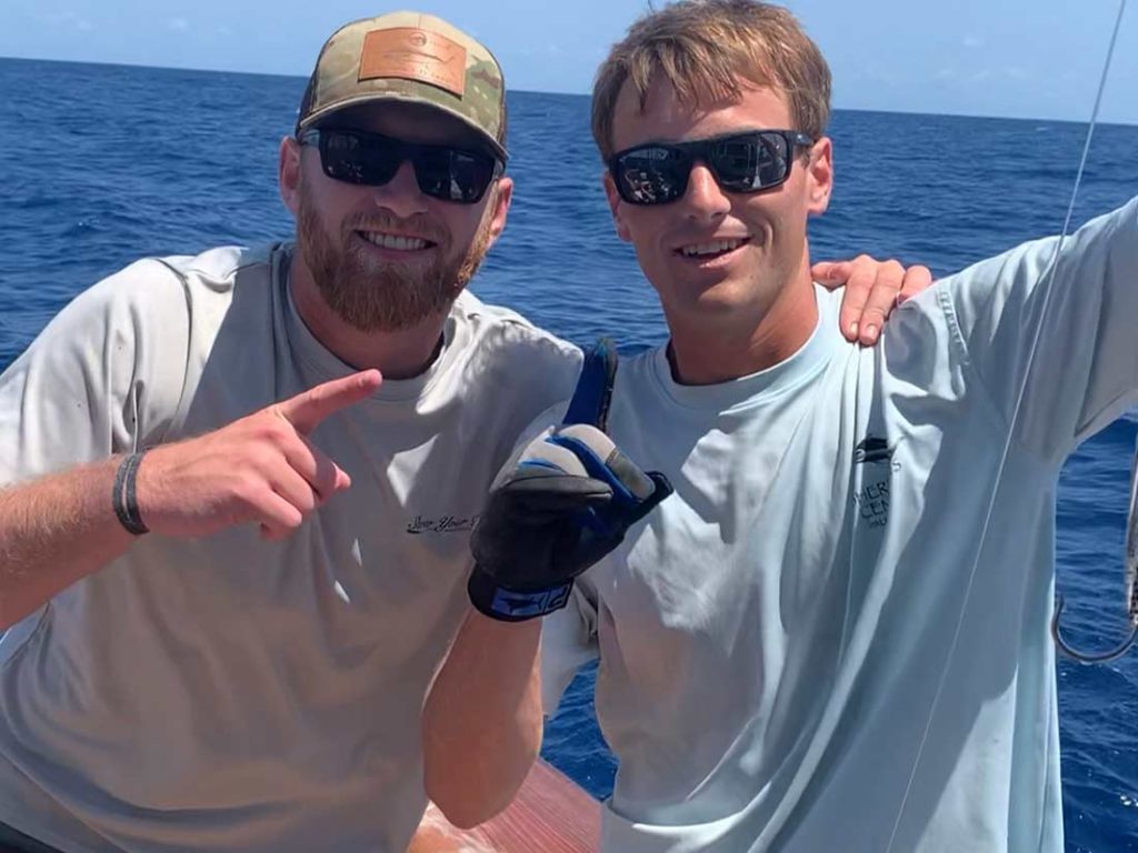 Two anglers on a fishing boat.