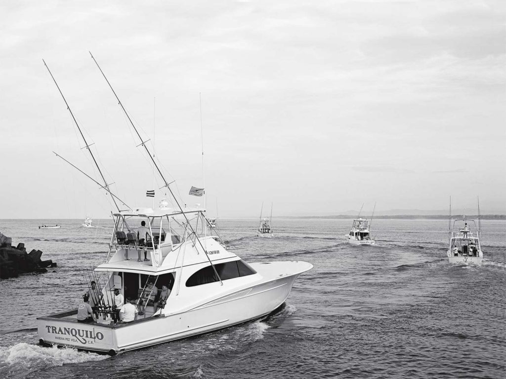 A black and white image of sport-fishing boats on the water.