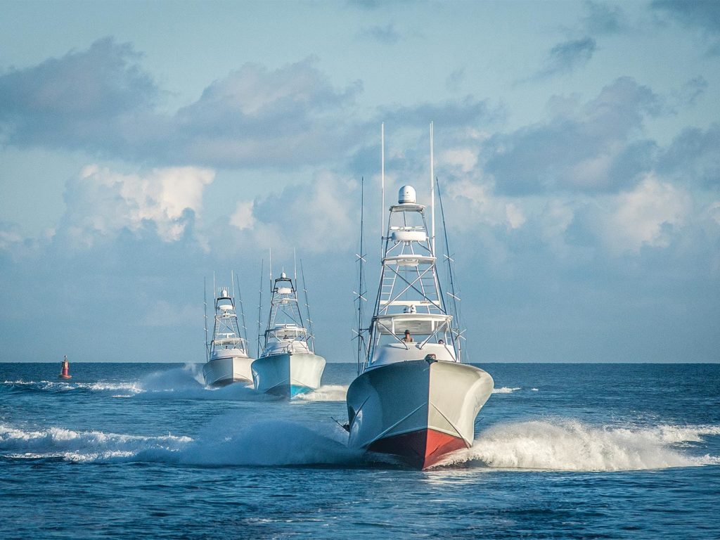 Three sport-fishing boats on the water.