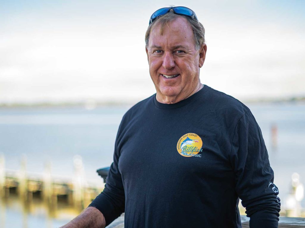 Portrait of a man standing in front of the ocean.