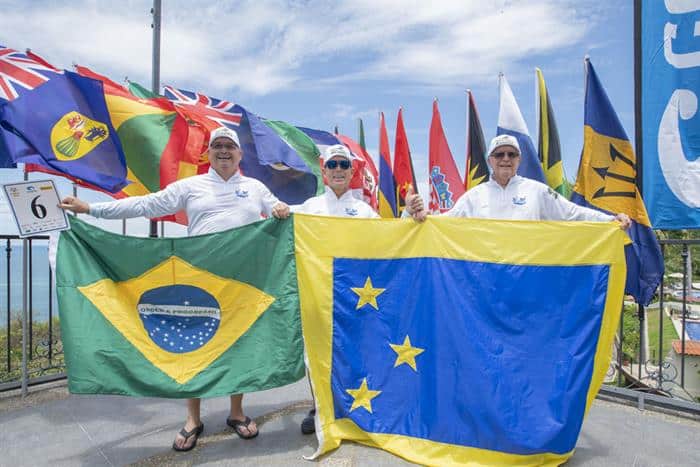 A fishing team holding up flags.