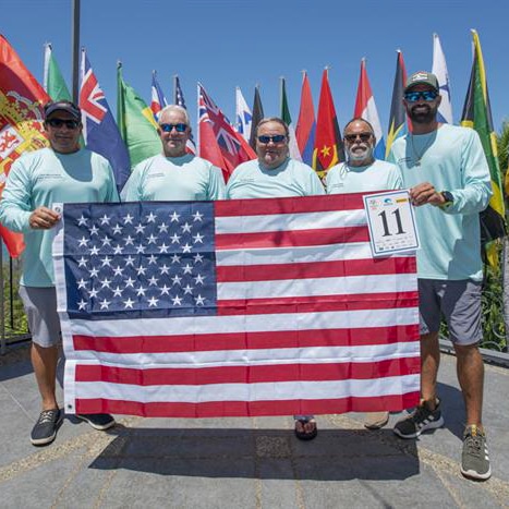 A group of anglers holding up an American flag.