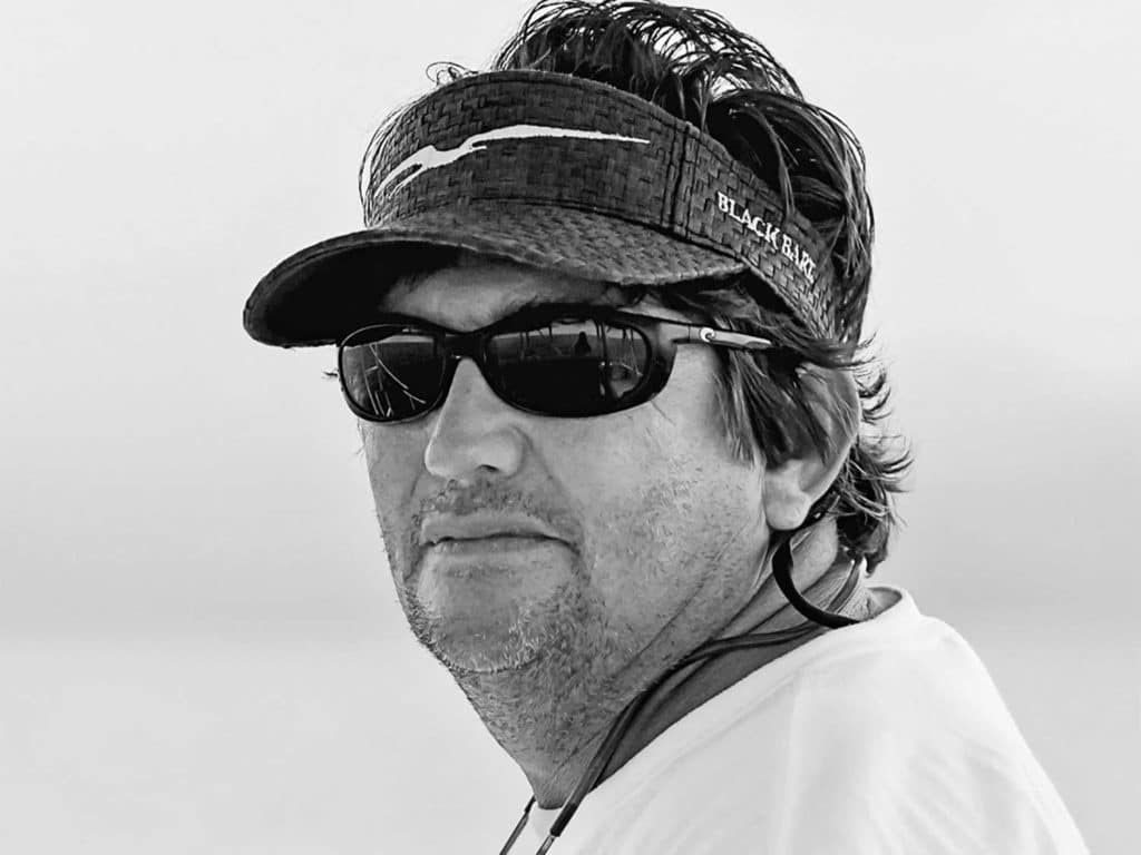 A black and white image of a boat captain.