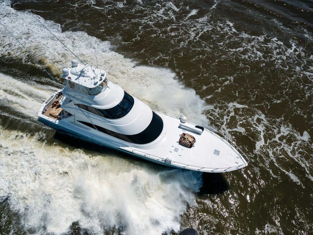 A sport-fishing boat making waves on the water.