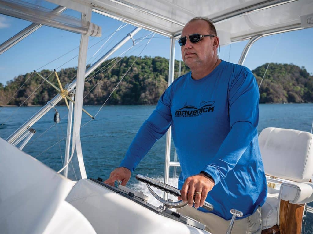 A sport-fishing captain behind the helm of the boat.