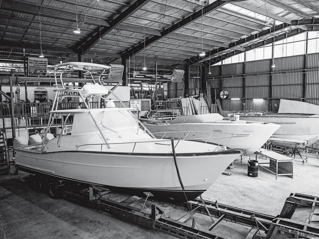A black and white image of boats in a warehouse.