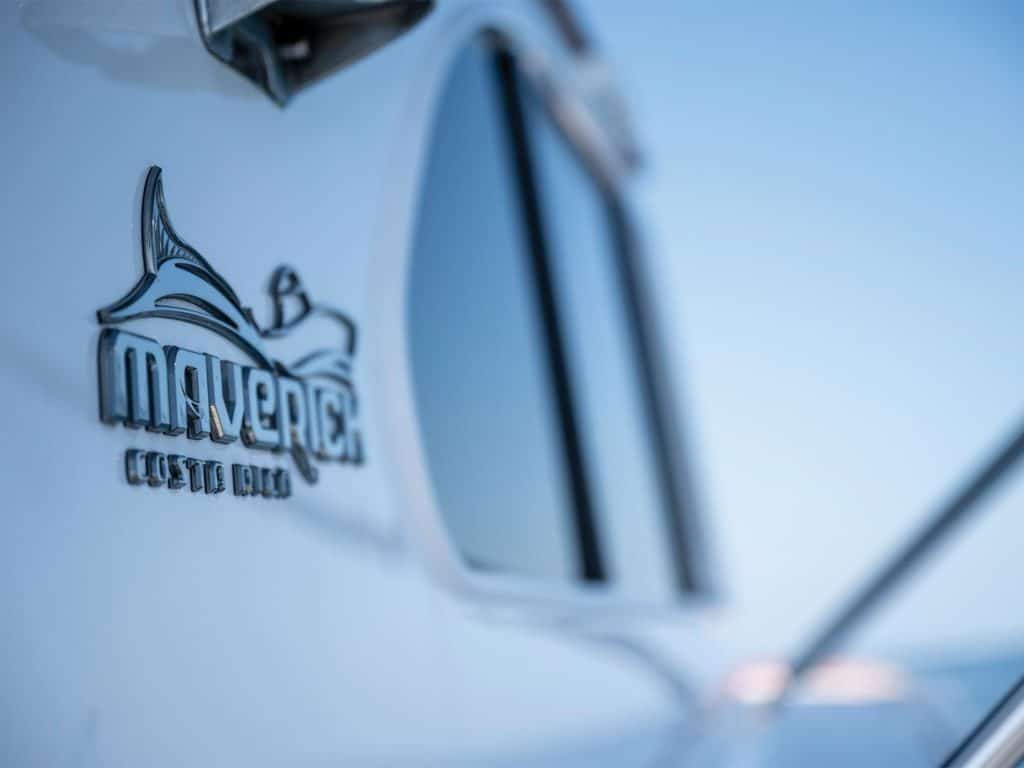 A close up of the Maverick brand logo on the hull of a sport-fishing boat.